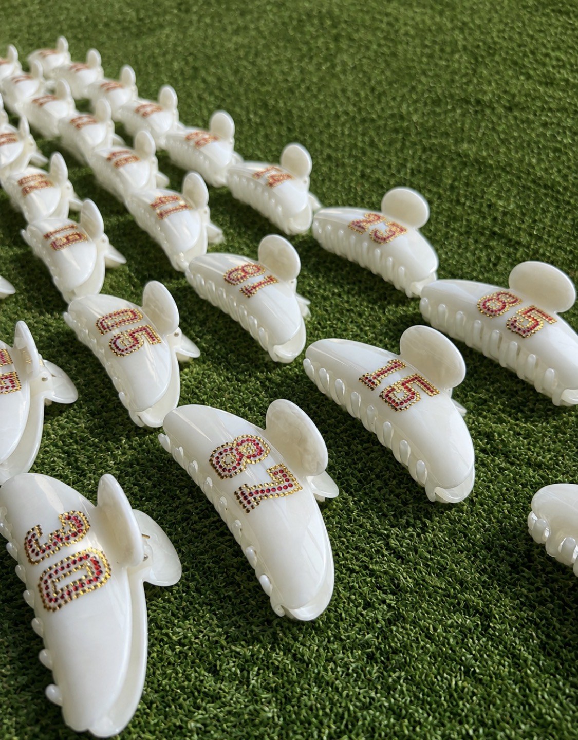 Custom cream clips displayed on grass