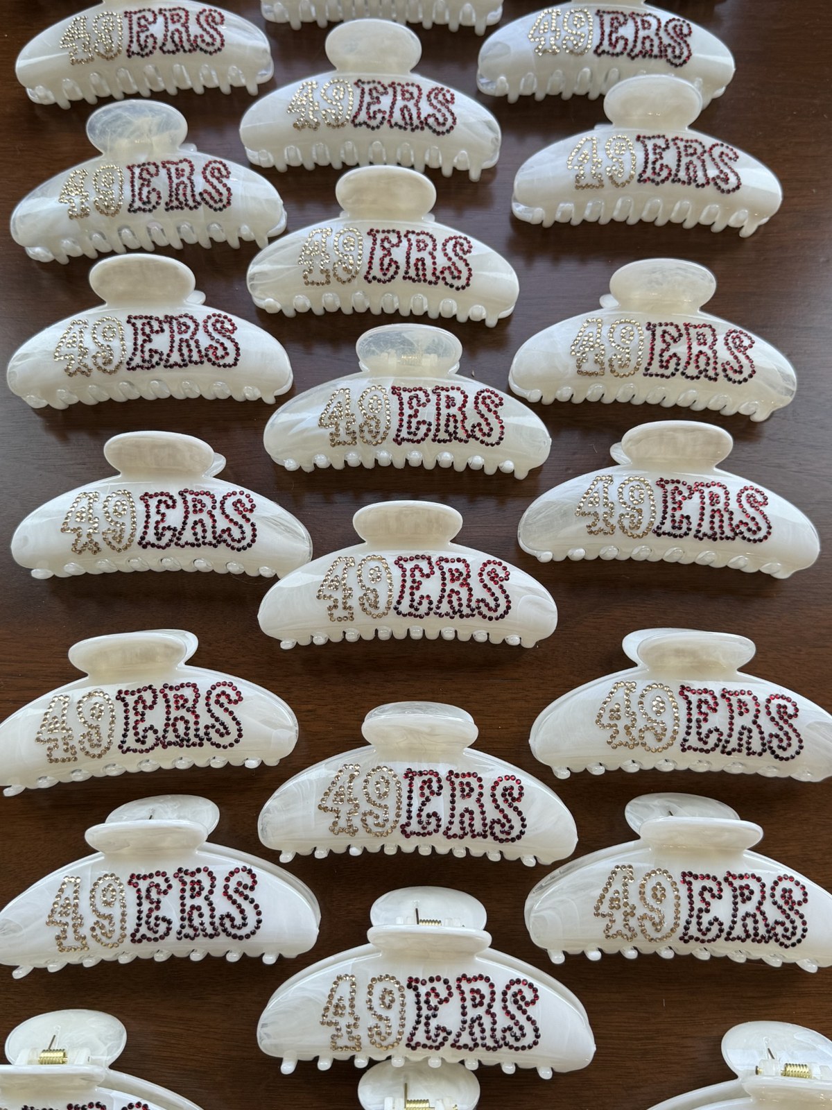 Rows of custom rhinestone logo clips