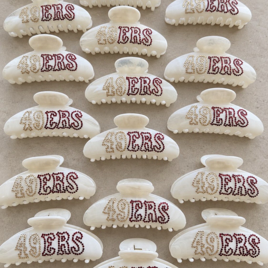 Cream clips with custom rhinestone lettering